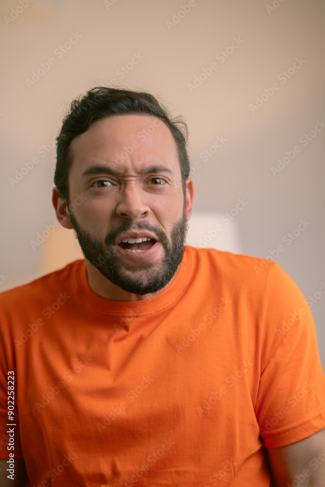 Obraz premium Hispanic man making a shocked expression on a white background