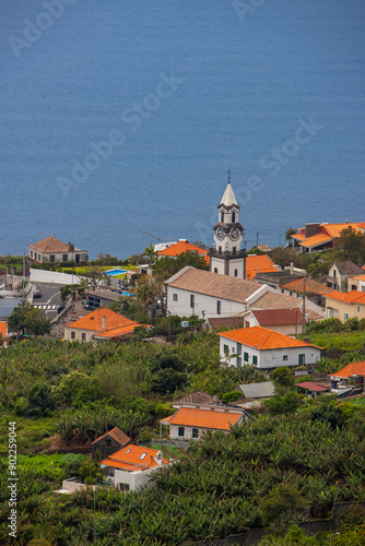 Hillside Village with Scenic Church and Red-Roofed Homes in Madeira Island, Portugal.