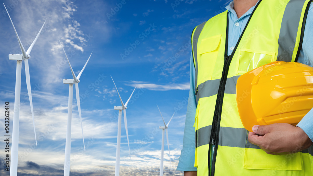 Picture of One Engineer working at windmill farm Generating electricity clean energy. Wind turbine farm generator by alternative green energy. Engineer checking control electric power. Picture of One Engineer working at windmill farm Generating electricity clean energy. Wind turbine farm generator by alternative green energy. Engineer checking control electric power.