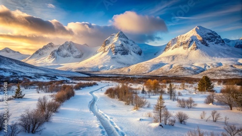 Majestic arctic landscape featuring a serene mountain hiking trail winding through snow-capped peaks and vast, untouched winter scenery in Scandinavia's frozen wilderness.