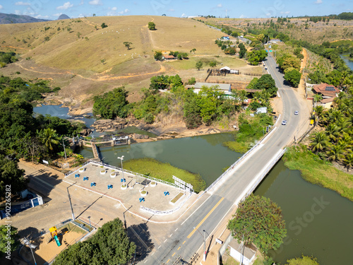 Aerial Drone view of the bridge over Sao Jose river and the small hydroelectric dam in Sao Gabriel da Palha, ES, Brazil photo