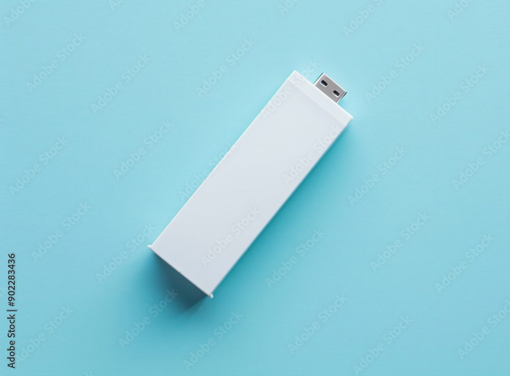 a white usb drive sitting on top of a blue surface a white usb drive sitting on top of a blue surface