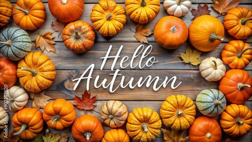 Hello Autumn Pumpkins and Fall Leaves on Rustic Wooden Background.