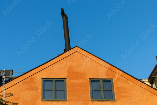 Canvas Print Stockholm, Sweden A rooftop and a chimney on an typical orange building facade