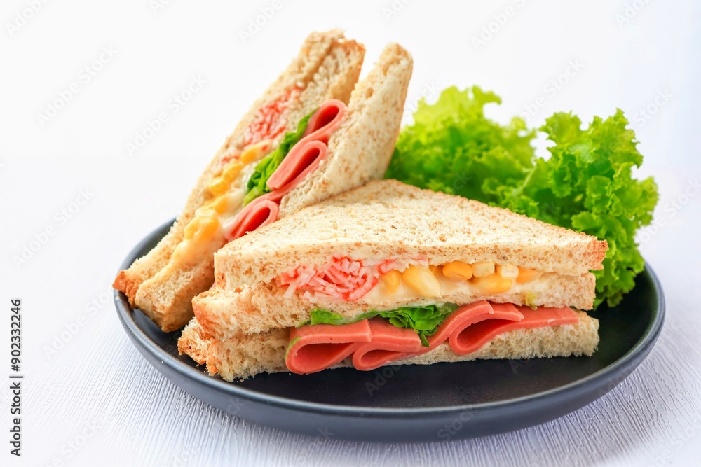 Homemade ham with sweet corn sandwich in black plate on white background Homemade ham with sweet corn sandwich in black plate on white background