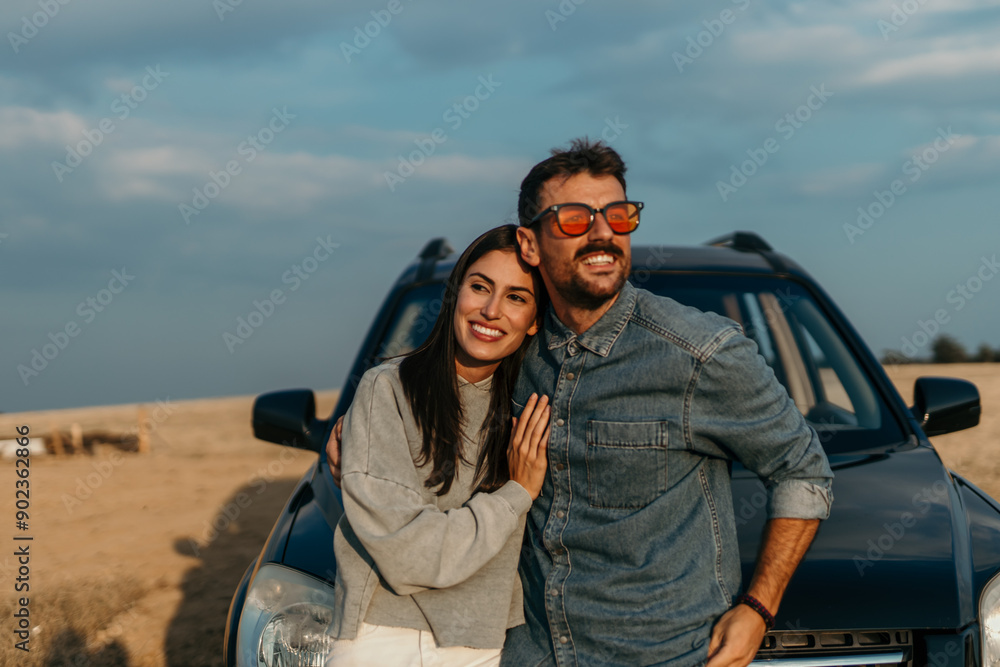 Shot of a young couple stopping to look at the view while on a road trip Shot of a young couple stopping to look at the view while on a road trip