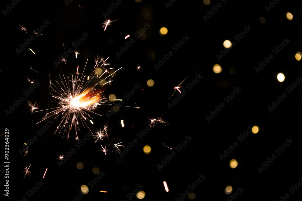 Obraz premium shiny fire sparkler on dark background