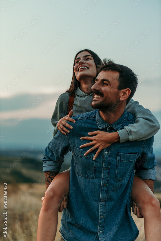 © La Famiglia - Couple having a piggyback ride, happy and smile hug in nature on a travel, adventure and road trip outdoor