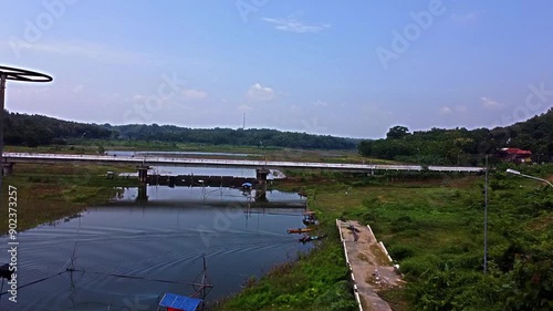 Scenic River View with Bridge and Lush Greenery photo