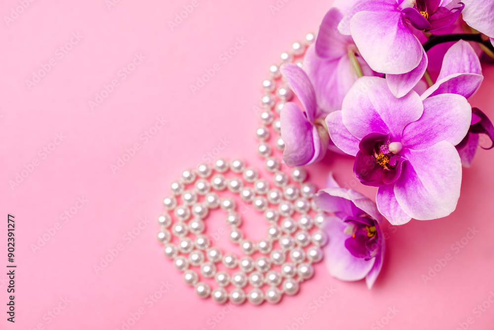 Pearl necklace and Purple orchid on pink background
Pearl necklace and Purple orchid on pink background