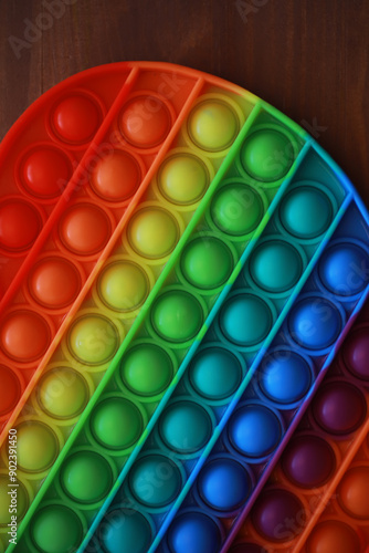 Colorful Rainbow Pop It Toy on Wooden Table - Stress Relief and Sensory Play photo