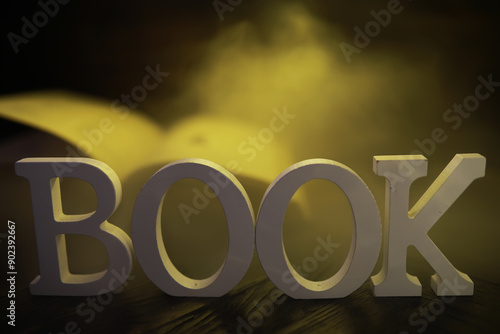 Wallpaper Mural White BOOK Letters on Wooden Table with Open Book and Yellow Light Background Torontodigital.ca