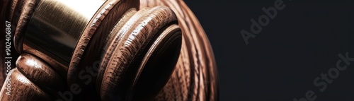 Close-Up of Wooden Gavel Against Dark Background in Tight Frame Representing Justice and Authority photo