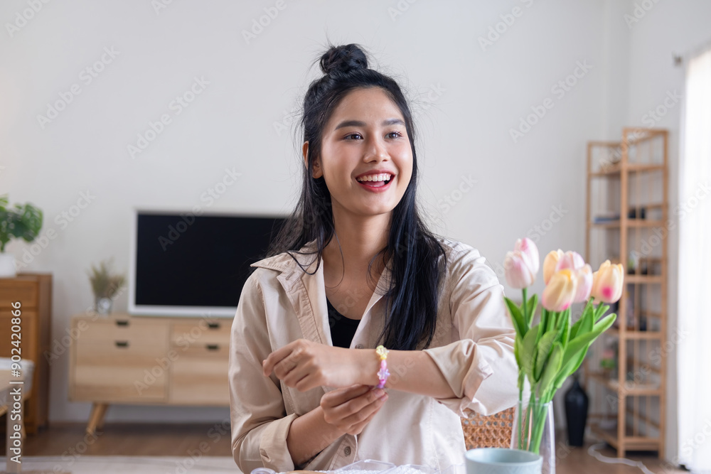 Young girl making handmade bracelets with fun and cheerfulness Young girl making handmade bracelets with fun and cheerfulness