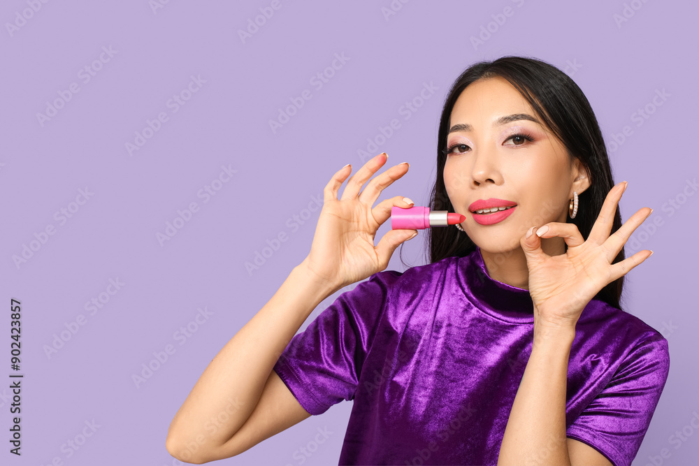 Beautiful Asian woman with lipstick showing OK on lilac background Beautiful Asian woman with lipstick showing OK on lilac background