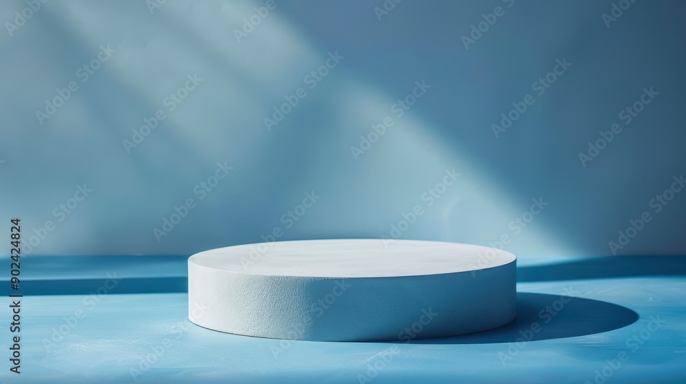 A white pedestal is sitting on a blue surface A white pedestal is sitting on a blue surface
