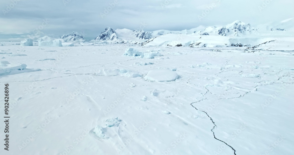 Towering mountains desert snow covered Antarctic landscape. Aerial drone fly over frozen ocean coast, ice floe crack. Beautiful South Pole winter wild nature footage. Antarctica travel and exploration Towering mountains desert snow covered Antarctic landscape. Aerial drone fly over frozen ocean coast, ice floe crack. Beautiful South Pole winter wild nature footage. Antarctica travel and exploration