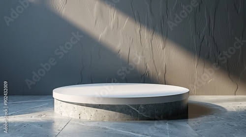 A white pedestal with a grey base is sitting in a room with a wall photo