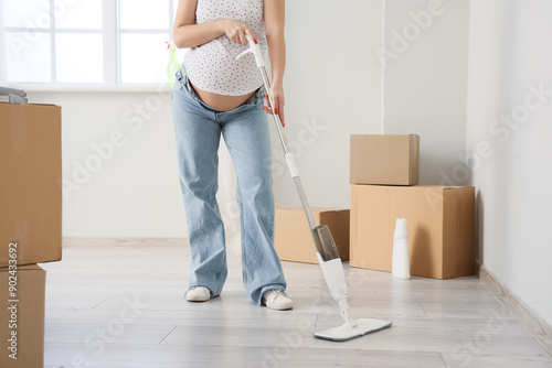 Pregnant woman mopping floo...