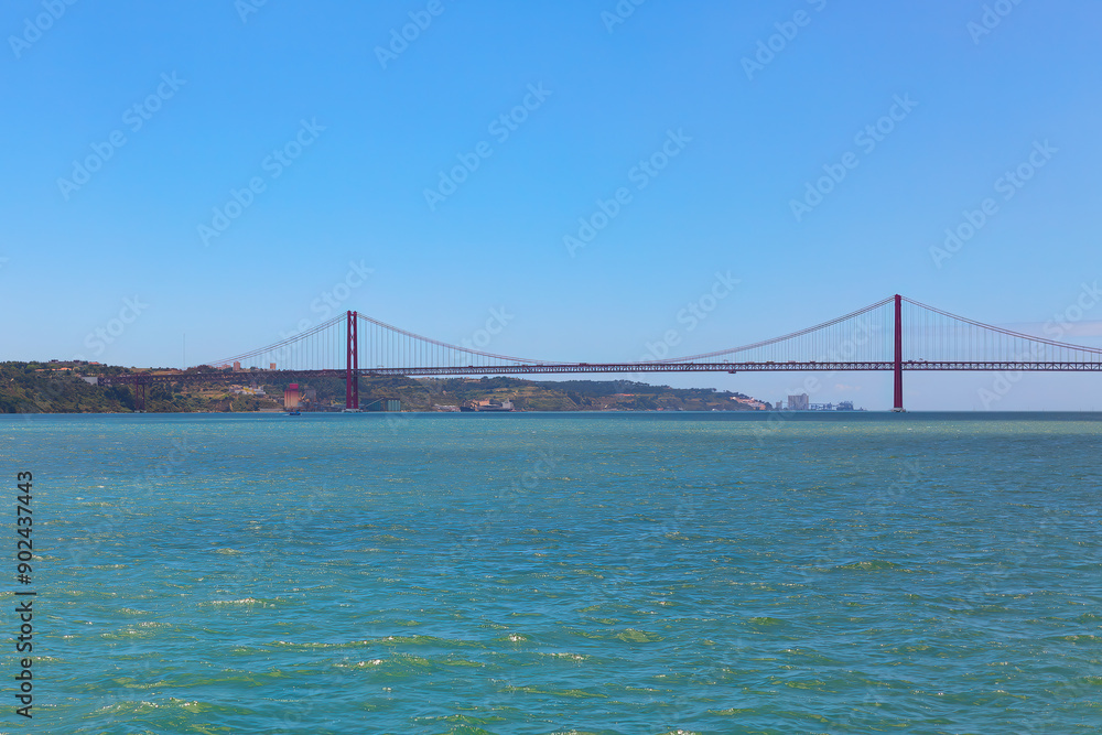 Golden Bridge in Lisbon, Portugal, overlooking the city with stunning views of the Tagus River Golden Bridge in Lisbon, Portugal, overlooking the city with stunning views of the Tagus River