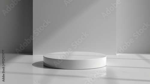 A white pedestal with a circular base is in a room with a white wall