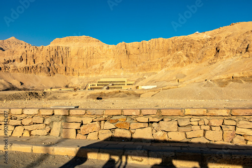 Experience the golden hour at the magnificent temple of Hatshepsut. As the sun rises over the Nile Valley, Djeser-Djeseru, the sacred terrace, is bathed in a warm, golden glow. photo