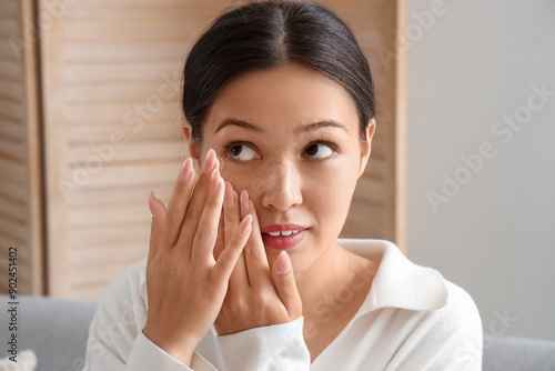 Young Asian woman putting i...
