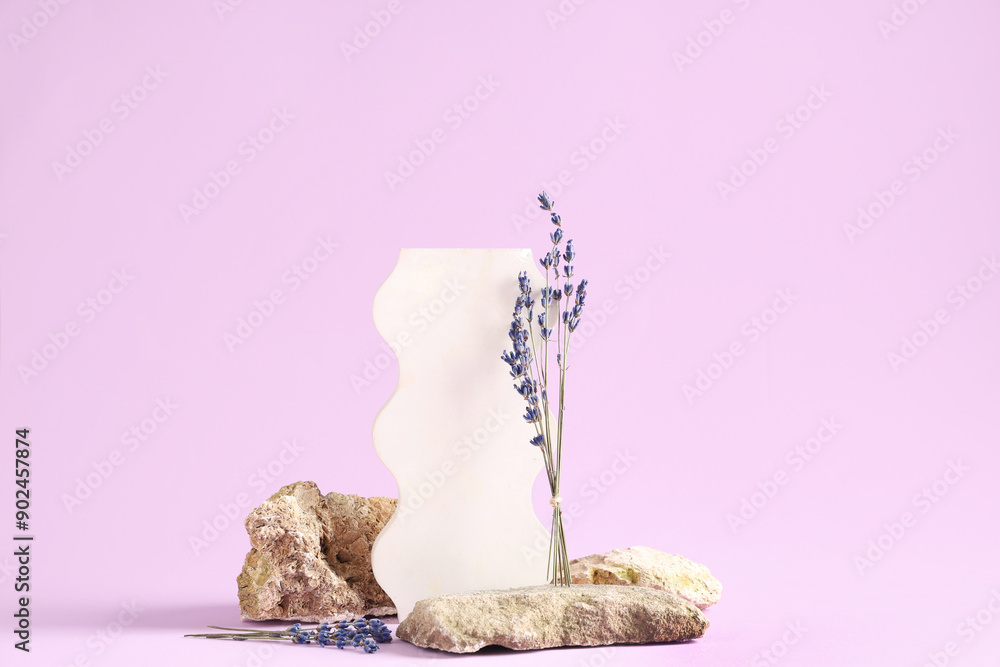 Decorative podium with lavender flowers and stones on lilac background Decorative podium with lavender flowers and stones on lilac background