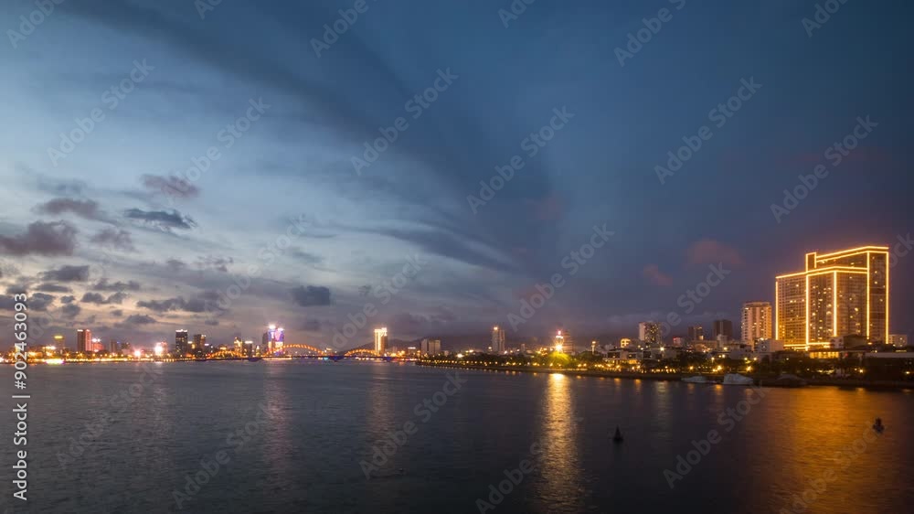 Da Nang cityscape ad blue hour withd dynamic clouds over waterside and glowing city lights, Vietnam. Da Nang cityscape ad blue hour withd dynamic clouds over waterside and glowing city lights, Vietnam.
