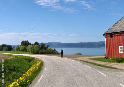 Woman biking on Inderøy in Norway, part of the 