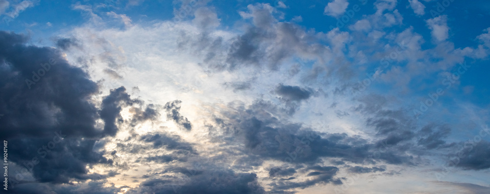 Dark blue clouds in the sky illuminated by the evening sun Dark blue clouds in the sky illuminated by the evening sun