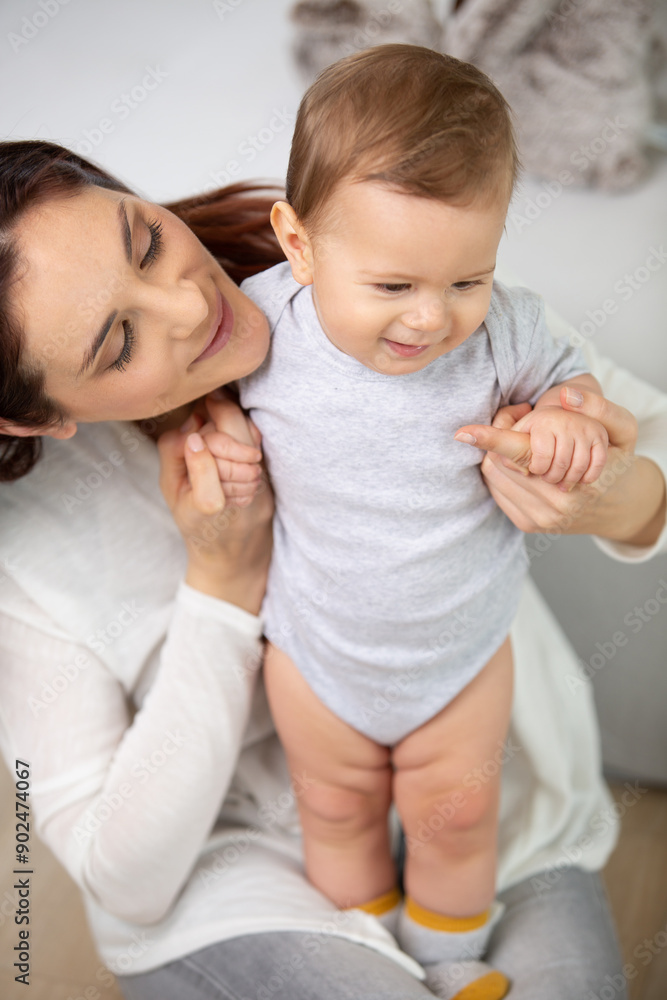 mother standing holds the child in her arms mother standing holds the child in her arms