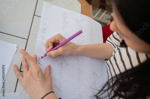 Woman hands writing, drawing with pencil close up. German wort möchte translated as like. placate creating.	
 photo