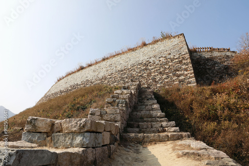 Low angle and autumnal view of stone stairs and rampart at Gomosanseong Fortress of Sinhyeon-ri near Mungyeong-si, South Korea
 photo