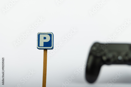 Wooden Parking Signal and Unfocused Game Remote photo