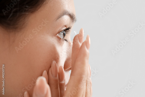 Young Asian woman putting i...