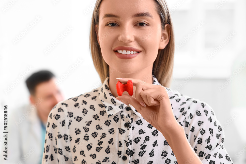 Young woman with thyroid gland model at endocrinologist's office, closeup Young woman with thyroid gland model at endocrinologist's office, closeup