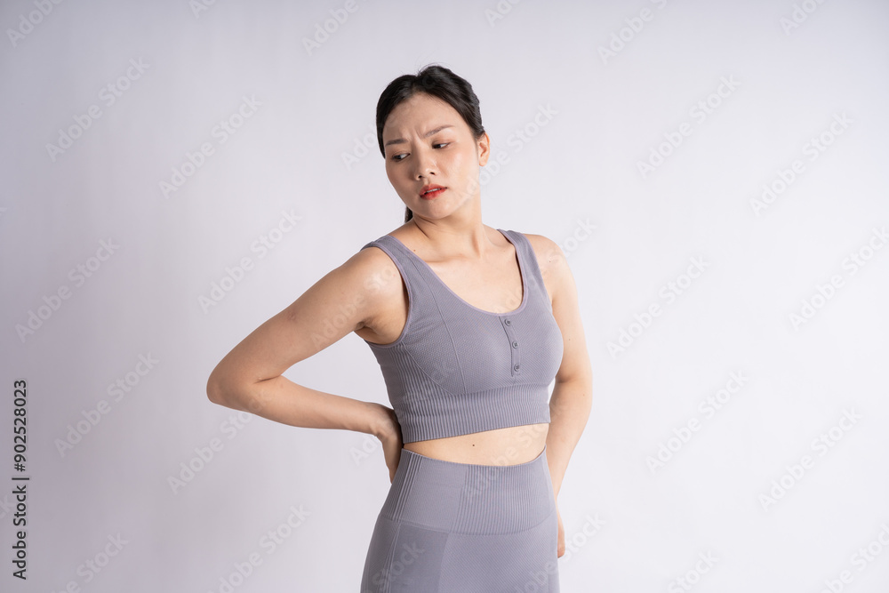 Portrait of Asian woman wearing sportswear, posing on white background Portrait of Asian woman wearing sportswear, posing on white background