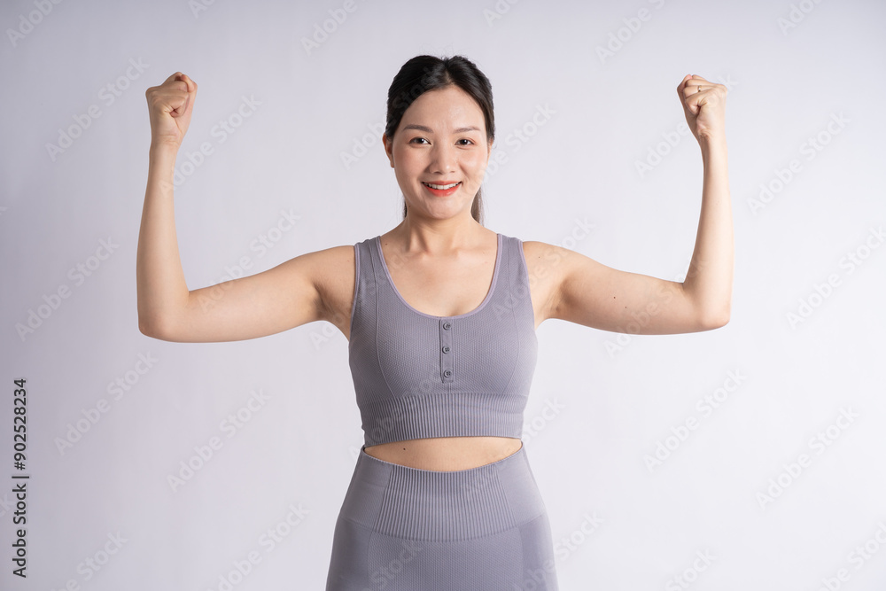 Portrait of Asian woman wearing sportswear, posing on white background Portrait of Asian woman wearing sportswear, posing on white background