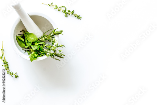 Homeopathy with leaves and healing herbs for making oil on white photo