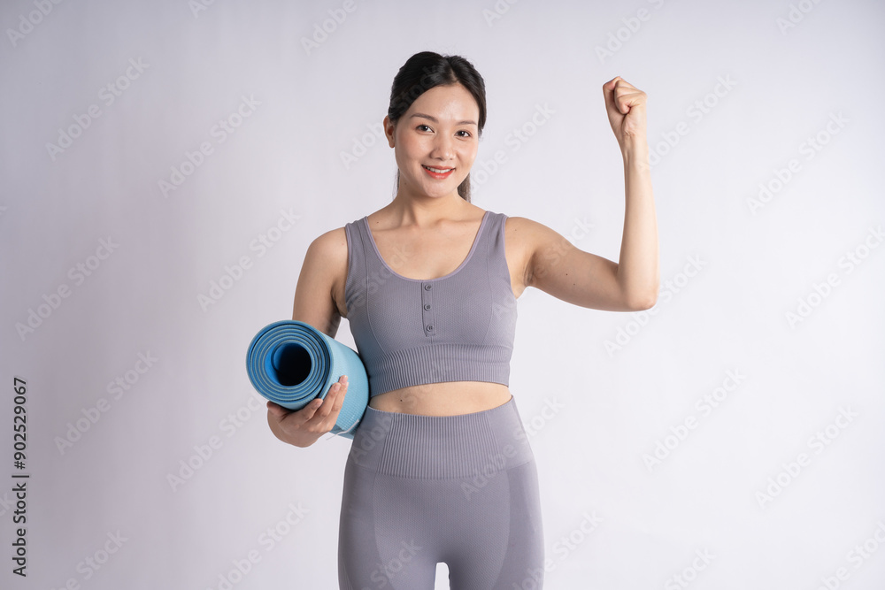 Portrait of Asian woman wearing sportswear, posing on white background Portrait of Asian woman wearing sportswear, posing on white background