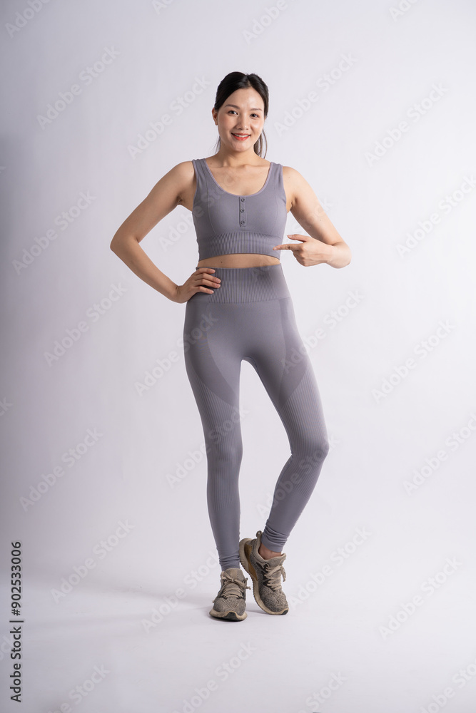 Portrait of Asian woman wearing sportswear, posing on white background. Portrait of Asian woman wearing sportswear, posing on white background.