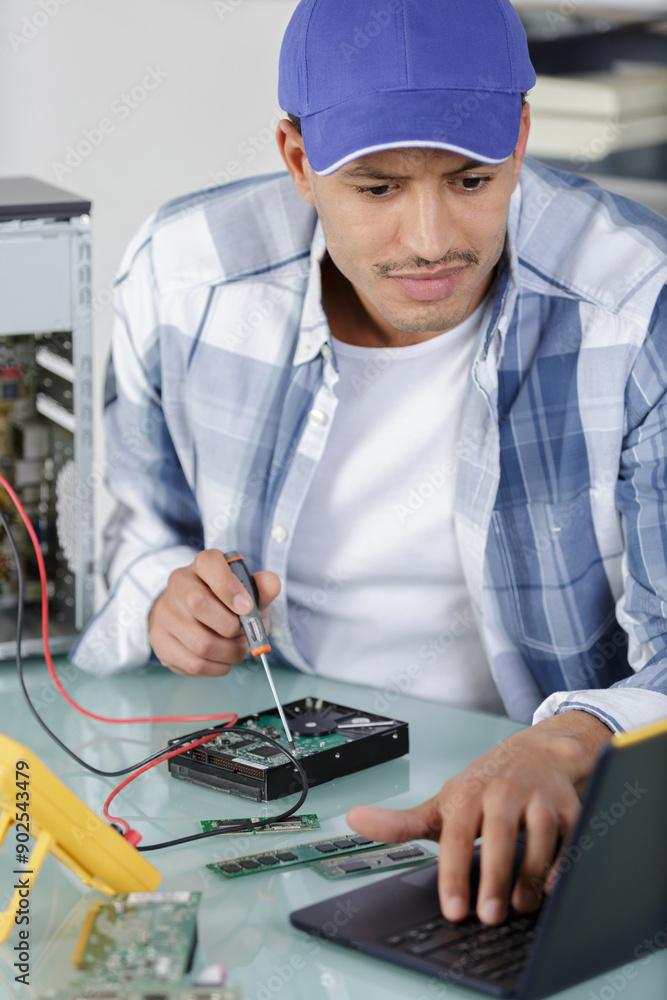 man repairing computer part in service center man repairing computer part in service center