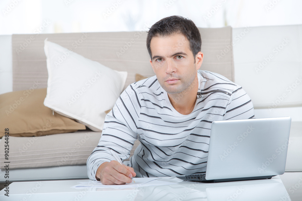 man in the living room with laptop man in the living room with laptop