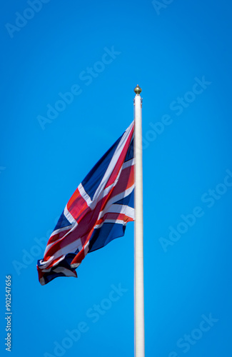 British Union Jack flag blowing in the wind on flag pole