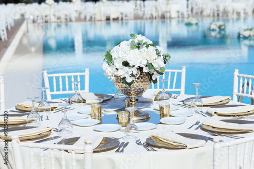 Obraz na płótnie Romantic poolside wedding setup with white chairs and white linens w salonie