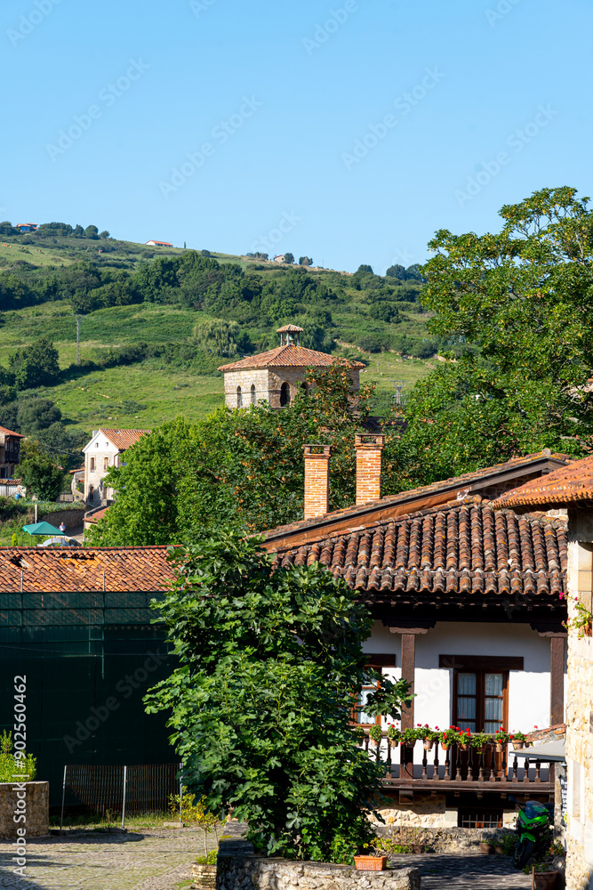 Panoramic view of the picturesque town of Santillana del Mar in Cantabria, Spain. The landscape features traditional stone buildings, lush green fields, and a clear blue sky. Panoramic view of the picturesque town of Santillana del Mar in Cantabria, Spain. The landscape features traditional stone buildings, lush green fields, and a clear blue sky.