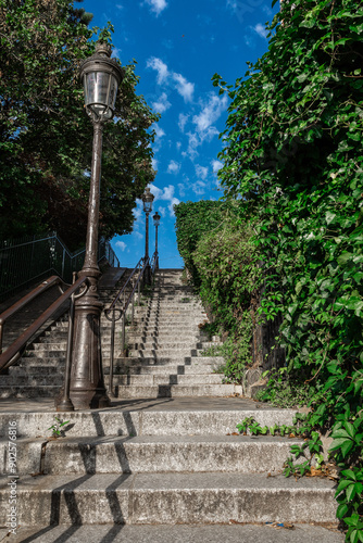 Obraz na płótnie Stairs leading up to the top of the Montmartre hill in Paris, eastern access stairs to famous Sacre Couer or Holy Cross church overlooking Paris w salonie