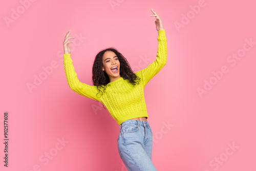 Photo portrait of young latin girl teenager party chilling fingers pointing up celebrating and singing isolated on pink color background