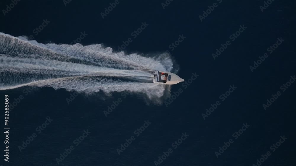 custom made wallpaper toronto digitalAerial view of a lone boat speeding across the calm, dark blue ocean, leaving a trail of white waves behind. The simplicity and tranquility of the vast sea contrast with the boat's motion